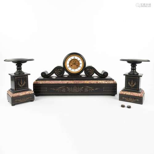 A three-piece mantle garniture clock and side pieces made of...