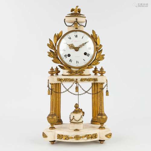 A column mantle clock made of marble mounted with bronze in ...