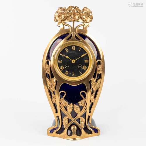 A table- or mantle clock made of porcelain mounted with bron...