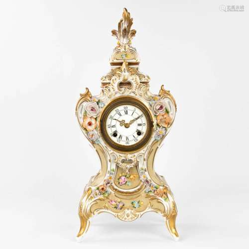 A mantle clock made of porcelain in rococo style with flower...