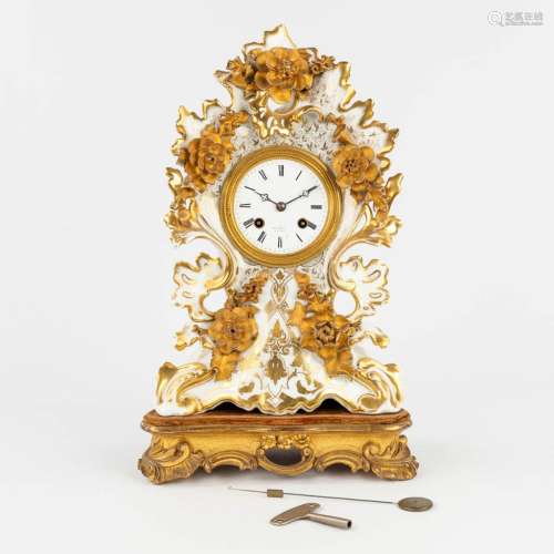 A porcelain table clock with gold-white floral decor. 19th C...