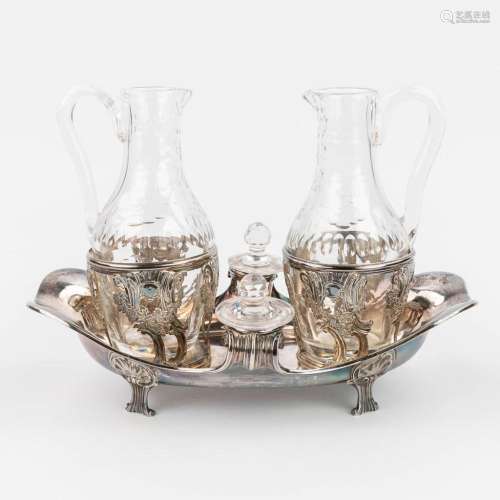 An antique oil and vinegar set, made of cut crystal and silv...