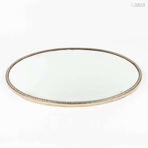 A serving tray with a mirror and silver rim. Not marked. (L:...
