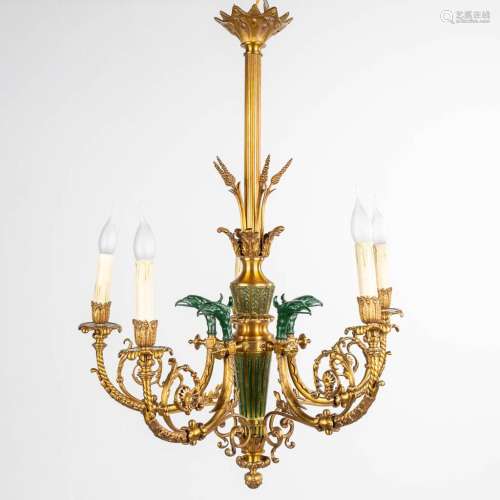 A chandelier made of bronze in empire style, decorated with ...