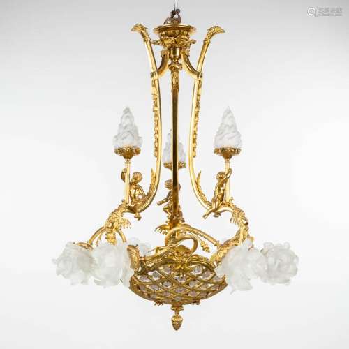 A chandelier made of gold-plated bronze, decorated with putt...