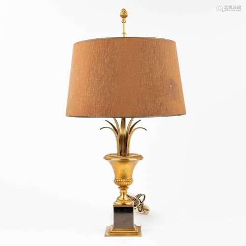 A table lamp made of brass and bronze in Hollywood Regency s...