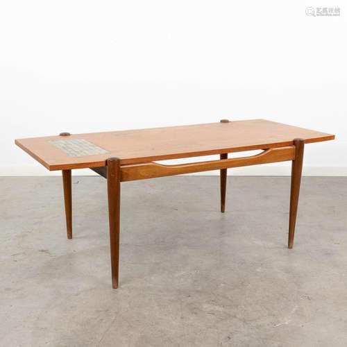 A mid-century coffee table with a turnable table top, and in...