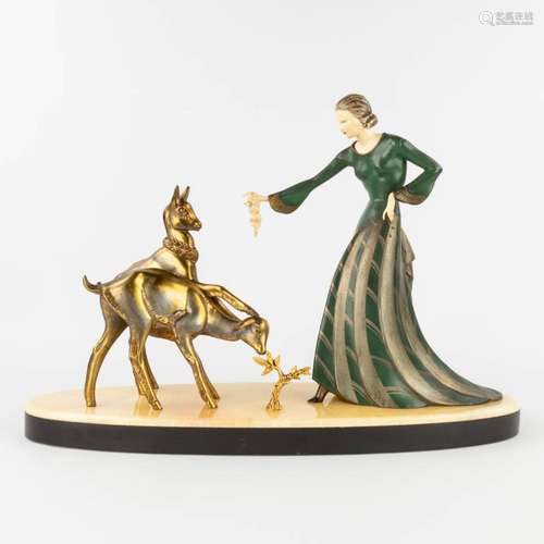 Lady feeding the deer, a statue made in art deco style. Spel...