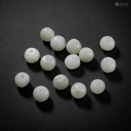 A GROUP OF HETIAN JADE BEADS FROM THE LIAO AND JIN PERIOD OF...