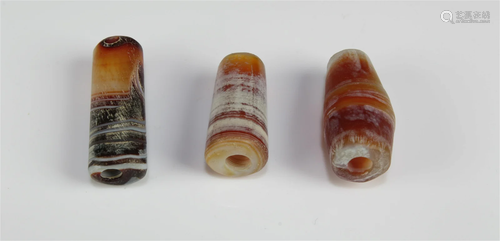 A Group of Three Tibetan 'First-Line' Dzi Beads