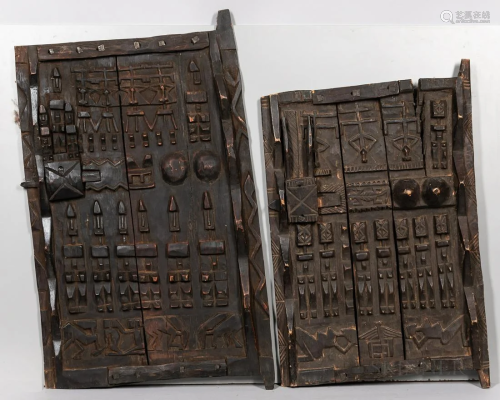 Two Dogon Carved Granary Doors, carved with raised figures a...