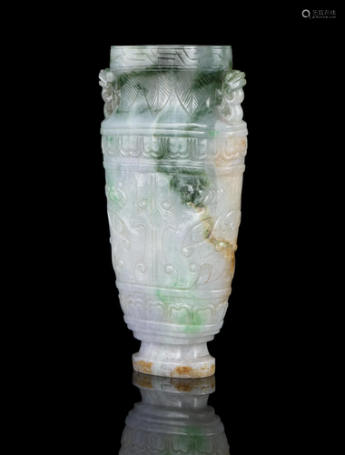 AN APPLE GREEN ACCENT MILKY JADEITE JADE ‘TAOTIE MASKS’ VASE...