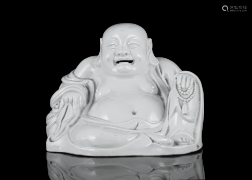 A DEHUA / BLANC DE CHINA MOLDED FIGURE OF A BUDAI OR PUTAI C...