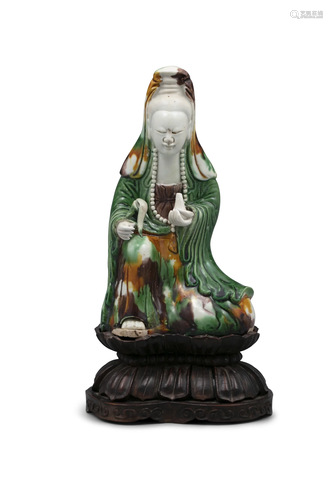 AN EGG AND SPINACH MOLDED BISCUIT PORCELAIN FIGURE OF A GUAN...