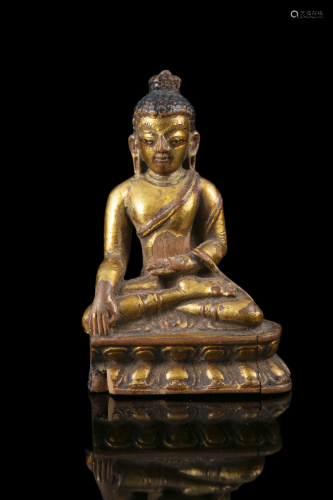 A SMALL GILT LACQUERED WOODEN FIGURE OF A BUDDHA CALLING THE...
