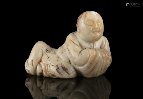 A SHOUSHAN STONE CARVING OF A RECLINING LUOHAN OR ARHAT CHIN...