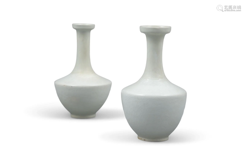 A NEAR PAIR OF CREAM-GLAZED CERAMIC ‘DRAGON’ BOTTLE VASES CH...