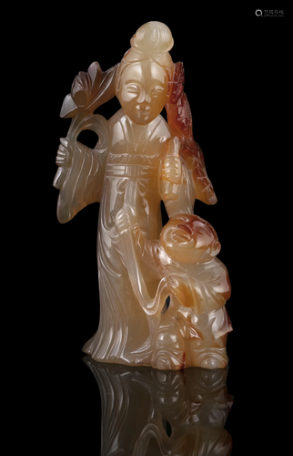 AN AGATE CARVING OF A LADY WITH A BOY CHINA, MAYBE CIRCA 190...