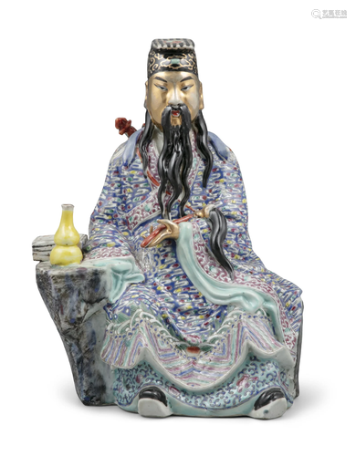 A FAMILLE ROSE PALETTE MOLDED PORCELAIN FIGURE OF A DAOIST G...