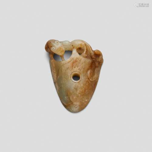 AN ARCHAISTIC SHIELD-SHAPED CELADON AND RUSSET JADE FINIAL M...