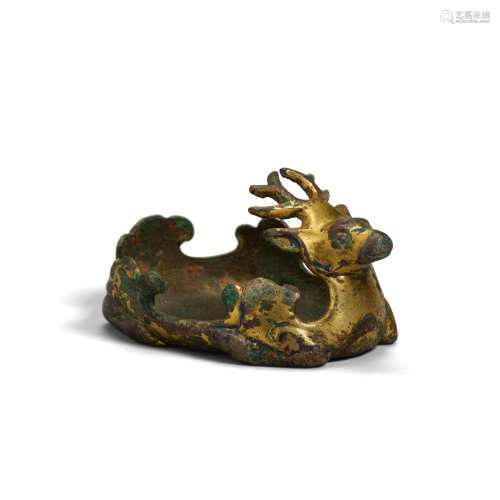 A RARE GILT-BRONZE FITTING IN THE FORM OF A RECUMBENT STAG H...
