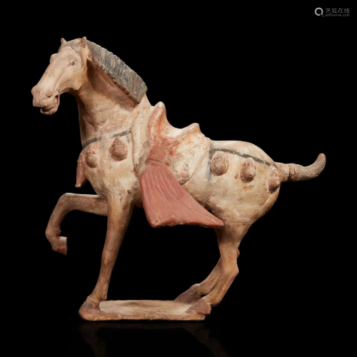 A Chinese painted pottery figure of a prancing horse Tang dy...
