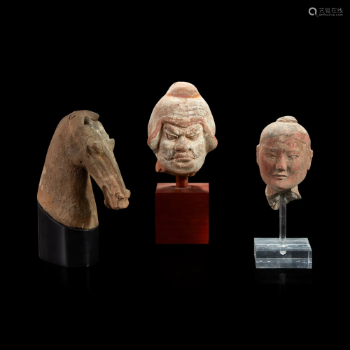 Three Chinese pottery heads of two men and a horse Han dynas...