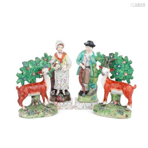 A pair of Staffordshire models of deer and a pair of figures...