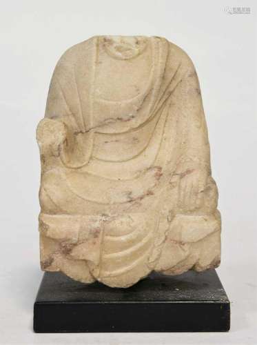 A mottled white marble seated headless Buddhist deity, perha...