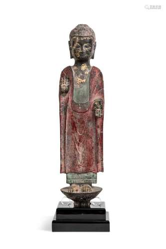 A Chinese painted and parcel gilt grey stone standing figure...