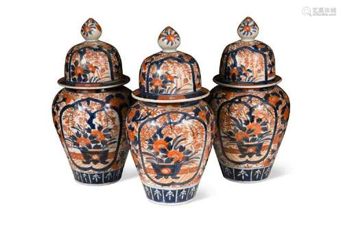 A Japanese garniture of three Imari vases and covers, late 1...