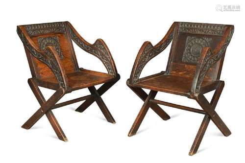 A near pair of Glastonbury style oak armchairs, 19th century...