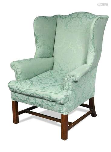 A George III mahogany wing back armchair,