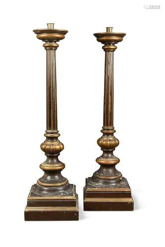 A large pair of brown and gilt painted pricket candle stands...