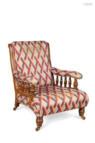 A late Victorian walnut and ebonised open armchair,