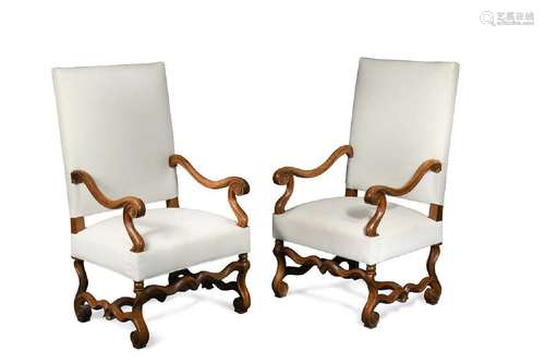 A pair of French Louis XIV style walnut open arm chairs,