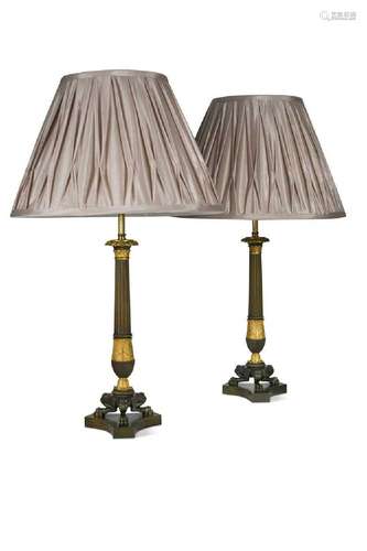 A large pair of Regency bronze and ormolu triform candlestic...