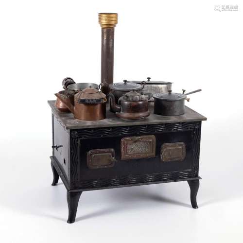 BLACK TIN STOVE WITH POTS.