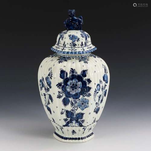 FAIENCE LIDDED VASE WITH FLORAL BLUE PAINTING.