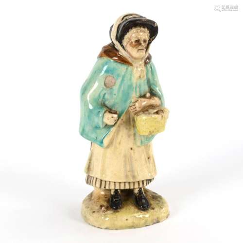 OLD WOMAN WITH BASKET. STAFFORDSHIRE POTTERY.
