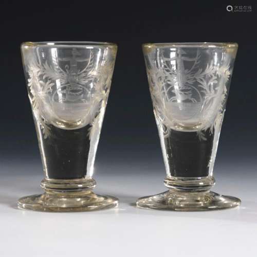 PAIR OF BAROQUE SHOT GLASSES WITH COAT OF ARMS DEPICTION.