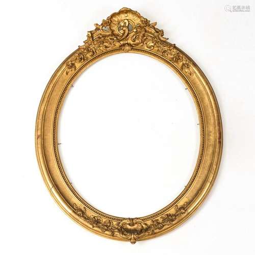 VERY LARGE OVAL GOLD STUCCO FRAME IN BAROQUE STYLE.