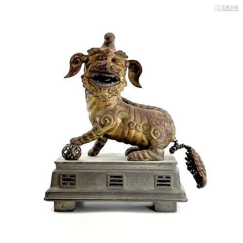 A Chinese gilt metal model of a dog of fo, late Qing Dynasty...