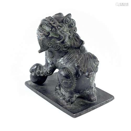 A Chinese bronze of model of a dog of fo, the base. with an ...