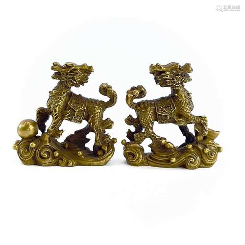 A pair of Chinese gilt metal scroll weights in the form of d...