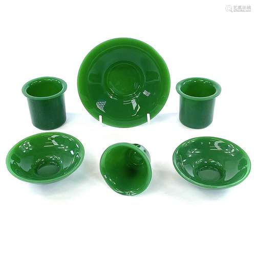 Two Peking green glass cups and saucers, one single saucer a...