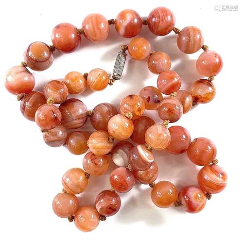 A carnelian stone bead necklace, length 64cm, 152 grams.