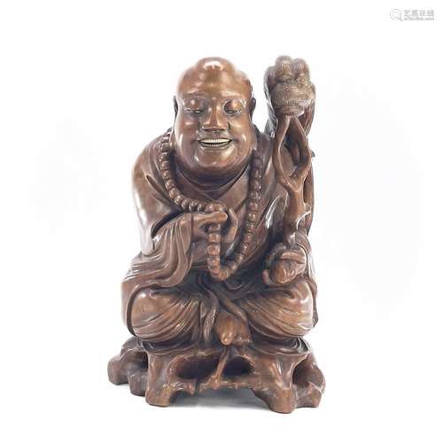 A large Chinese carved wood model of buddah, early 20th cent...