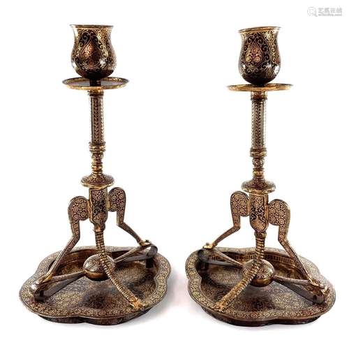 A pair of Persian gold damascened metal candlesticks, early ...