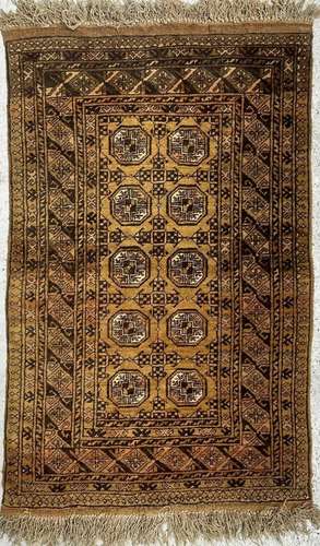 A golden Afghan rug, curca 1930s, with five rows of two octa...